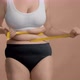 Excess Weight Caucasian Woman with Measure Tape Wrapped Around Her Waist - VideoHive Item for Sale