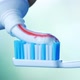 Dental Health - Squeezing Toothpaste with Colorful Stripes From a Tube Onto a Toothbrush. - VideoHive Item for Sale