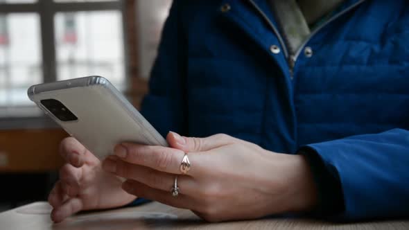 Hand of Girl Using Smartphone