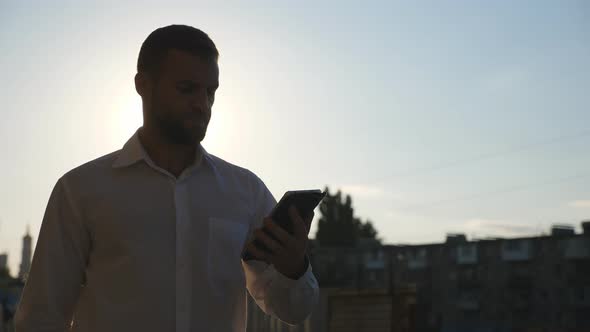 Close Up of Successful Businessman in Formal Wear Browses Mobile Phone Going to Job on Sidewalk