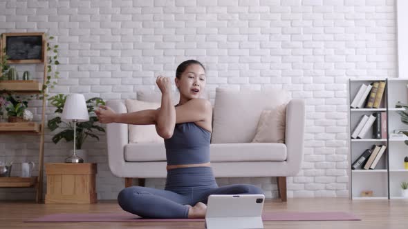 Asian woman pilates exercise yoga online course at home