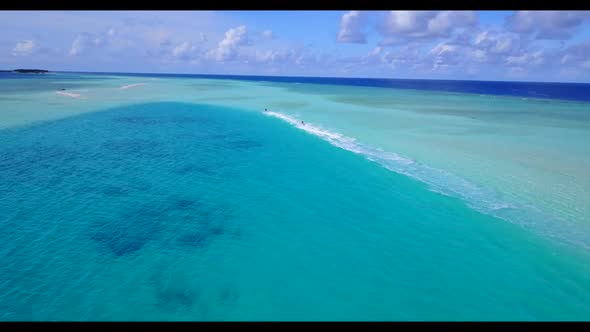 Aerial travel of idyllic coastline beach trip by blue ocean with white sand background of a dayout b