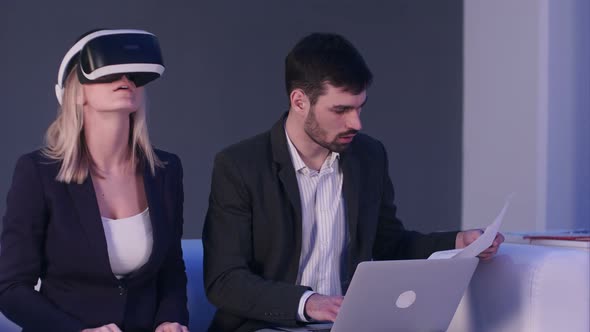 Blonde Woman in VR Headset Discussing Construction Project with Her Partner