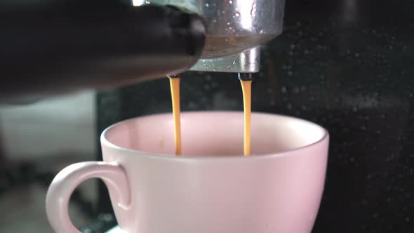 Footage B Roll of Pouring coffee stream from machine in cup. Home making hot Espresso.