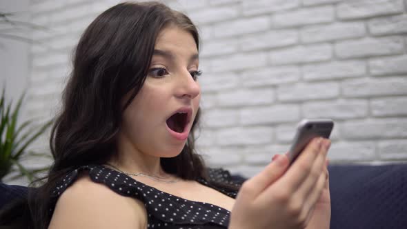Young Amazed Happy Attractive Woman Read Good News in Smartphone Shocked Female