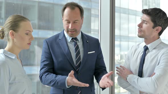Middle Aged Businessman Having Argument in Office
