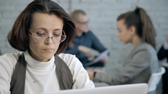 Mature Woman Using Laptop Display and Sending Mail