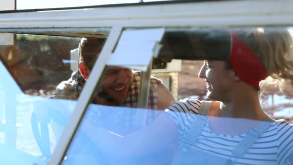 Couple interacting with each other near a car 4k