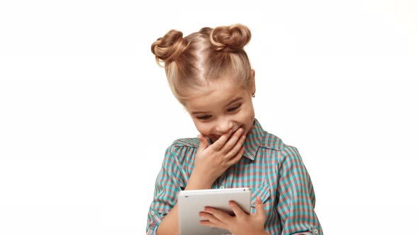 Young Adorable Caucasian Kid Girl in Plaid Shirt and Hair Buns Standing on White Background Looking