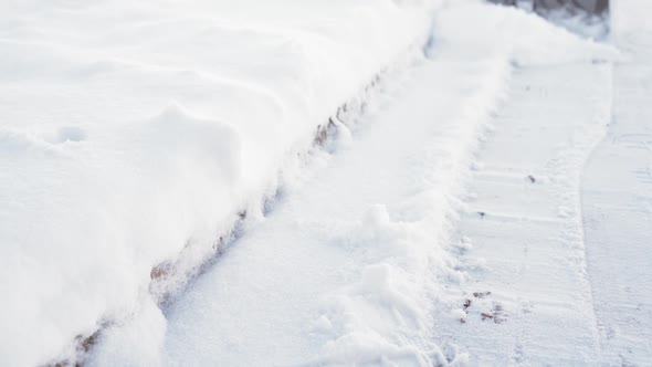 A Man Shovels Snow From a Path Closeup in Slow Motion