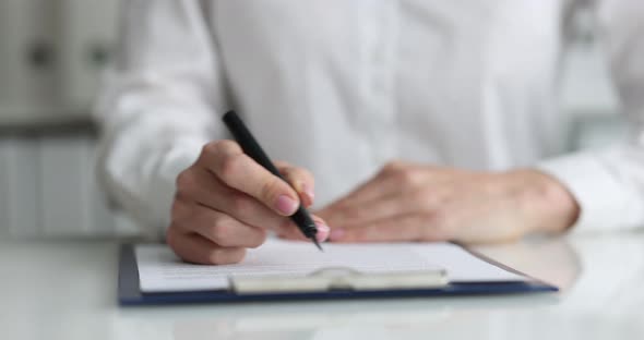 Businesswoman Examines Business Contract and Signs