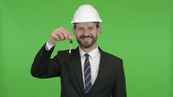 Ambitious Engineer with House Key and Money Against Chroma Key