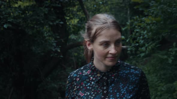 Portrait Shot of Freckled-Faced Woman Walking in the Woods Exploring