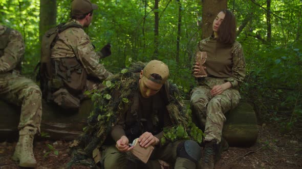 Marines Resting in Halt Preparing Rations to Eat in Forest Area