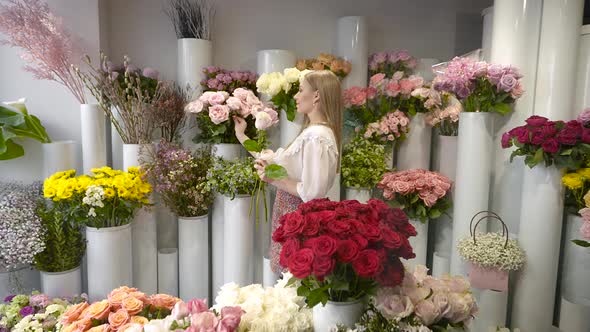 A Woman in a Flower Shop Collects a Bouquet