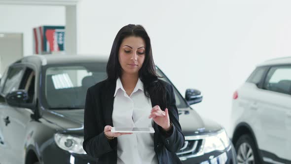 Attractive Elegant Business Lady Using Laptop with a Graphic Image of the Inscription AUTO SALON