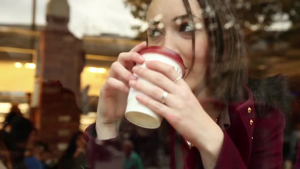 Beautiful woman in a cafe holding a cup of tea