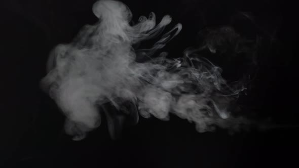 Vertically Positioned White Smoke Over Black Background