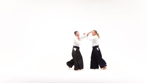 Two Males in Kimono Demonstrating Aikido Techniques, Isolated on White