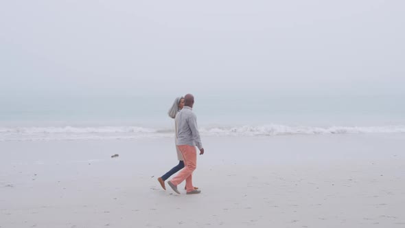 Mature couple enjoying time outside by the sea