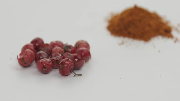 Red Pepper Powder Rotation. Macro Shot Against a White Background