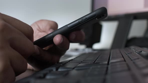 Fingers Scrolling On Mobile Above Keyboard. Low Angle, Locked Off, Close Up, Side View