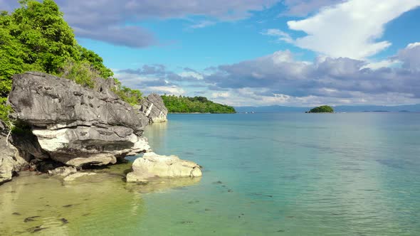 Tropical Island with a White Beach and Limestone Cliffs, Aerial View. Sabitang Laya