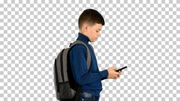 Schoolboy with a backpack using mobile phone, Alpha Channel