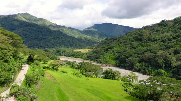 River in Mountain Valley with Bright Meadow