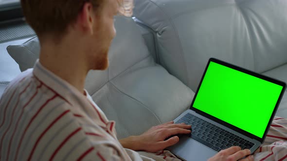 Guy Using Green Laptop Computer Closeup