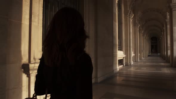 Woman in Black Dress Turning Over To Make a Photo Outside Louvre Museum