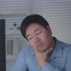 Tired Asian Male Worker Working on desktop computer in the Corporate Office, - VideoHive Item for Sale