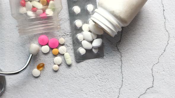  White Pills, Blister Pack and Stethoscope on White Background 