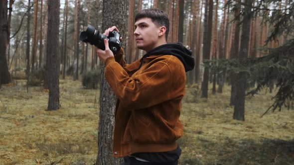 A Photographer Takes Pictures in the Woods a Young Man Takes Pictures in the Woods with His Camera