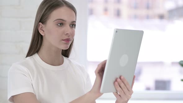 Portrait of Serious Young Woman Using Tablet