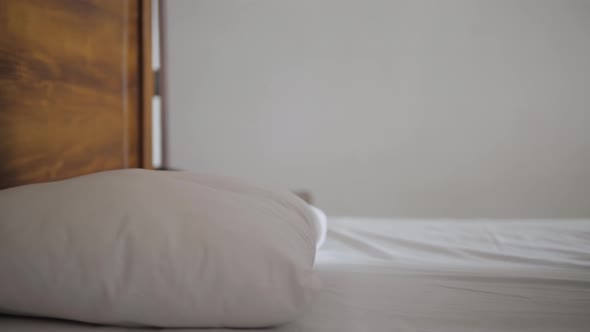 Closeup of Cheerful Young Beautiful Woman Lying on the Side in the Bed