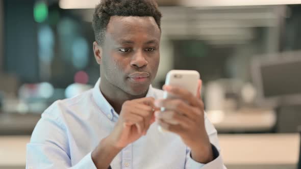 Portrait of African Businessman Loss on Smartphone