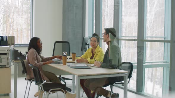 Multiethnic Business Team Having Meeting in Modern Office