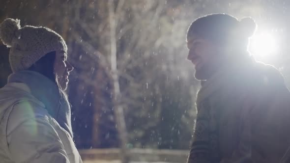 Young Couple Meeting in Park in Winter