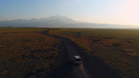 Car Driving Along Dirt Road