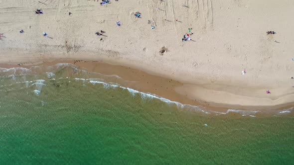 Top down aerial footage of the Bournemouth beach showing people relaxing on the beautiful beach