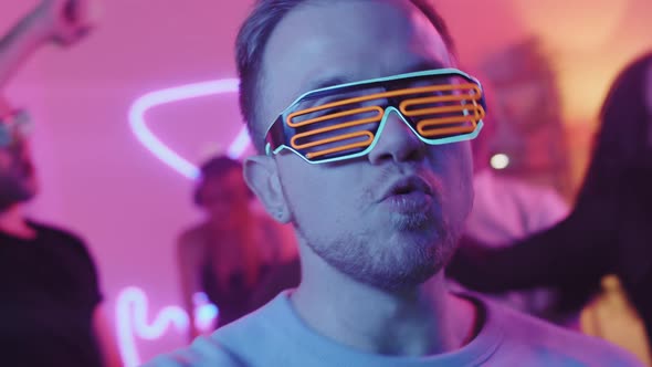 Man in Neon Sunglasses Partying Enthusiastically
