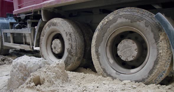 The Wheels of a Truck Go Through a Swamp at a Construction Site. Close Up