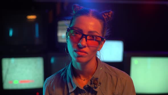 Close Portrait of Young Beautiful Girl with Nonworking TVs on the Background