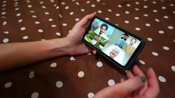 Woman making video call on smartphone at home