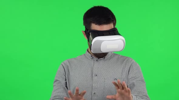 Portrait of Brunette Guy with Virtual Reality Headset or 3d Glasses. Green Screen