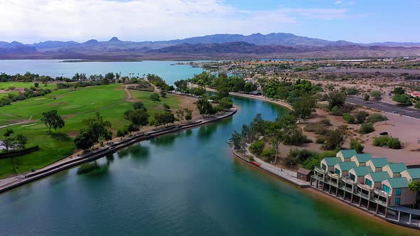 Drone aerial view flying down the beautiful canal of Lake Havasu in Arizona and panning up at the en