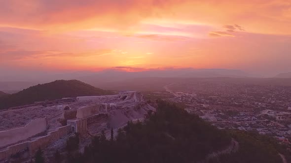 Ruins of Ancient Castle on Hiil and Valley in Sunset