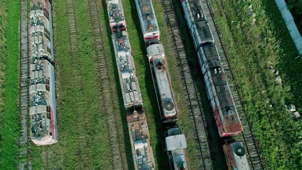 Aerial Tilt Shot of an Abandoned Rusty Locomotives and Old Railways