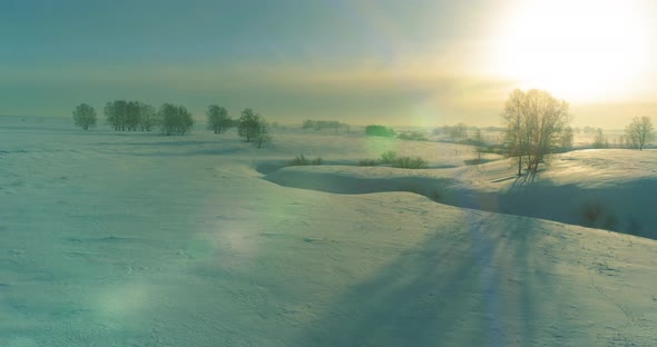 Aerial View of Cold Winter Landscape Arctic Field Trees Covered with Frost Snow Ice River and Sun